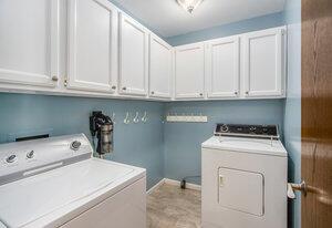 laundry area with washing machine and dryer and cabinet space
