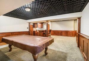 playroom with a wainscoted wall, pool table, and carpet