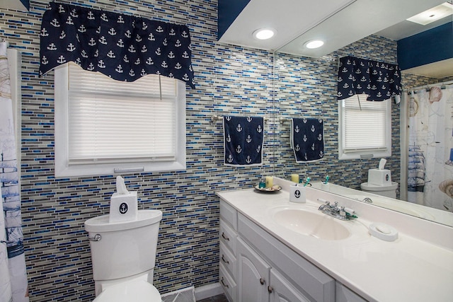 full bath with tile walls, toilet, recessed lighting, and vanity