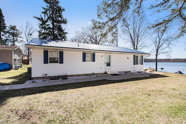 view of front of home with metal roof, a front lawn, crawl space, and entry steps