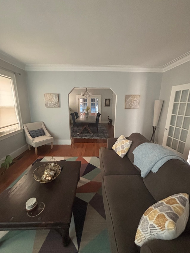 4074 Pasadena St, Detroit, MI 48238 - living area featuring arched walkways, crown molding, a healthy amount of sunlight, and wood finished floors