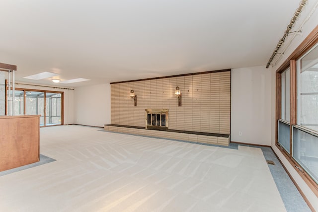 4710 Cove Rd, West Bloomfield, MI 48323 - unfurnished living room with carpet, a brick fireplace, and plenty of natural light