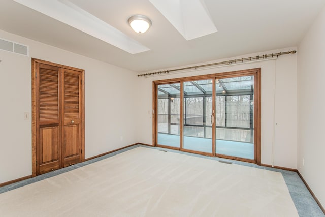 4710 Cove Rd, West Bloomfield, MI 48323 - unfurnished bedroom featuring light carpet, access to outside, baseboards, a skylight, and a closet