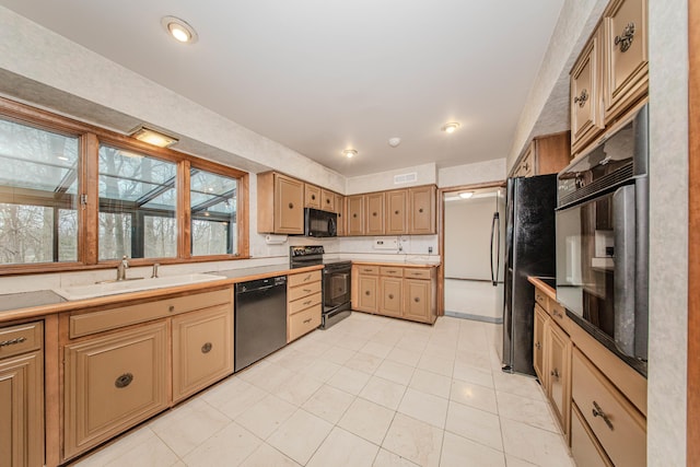 4710 Cove Rd, West Bloomfield, MI 48323 - kitchen featuring black appliances, a sink, light tile patterned floors, and light countertops