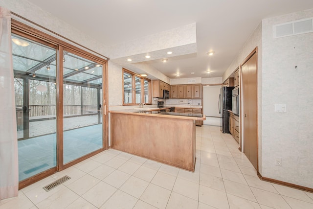 4710 Cove Rd, West Bloomfield, MI 48323 - kitchen featuring a peninsula, wall oven, a sink, healthy amount of natural light, and recessed lighting