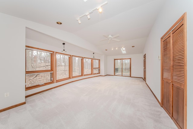 4710 Cove Rd, West Bloomfield, MI 48323 - unfurnished bedroom with lofted ceiling, baseboards, light carpet, rail lighting, and access to exterior