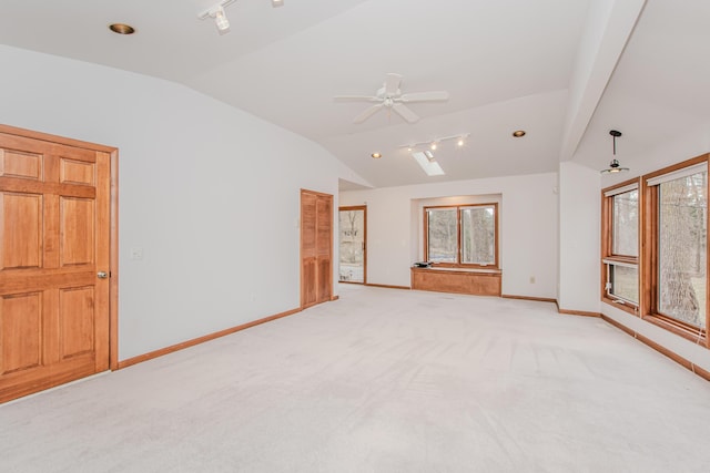 4710 Cove Rd, West Bloomfield, MI 48323 - spare room featuring rail lighting, lofted ceiling, baseboards, ceiling fan, and light colored carpet