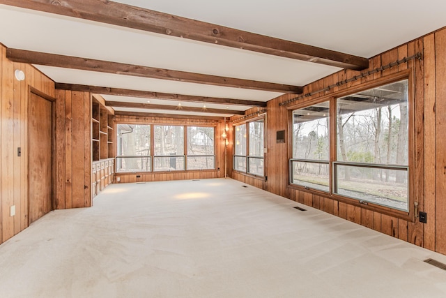 4710 Cove Rd, West Bloomfield, MI 48323 - unfurnished living room featuring wood walls, carpet floors, and beamed ceiling