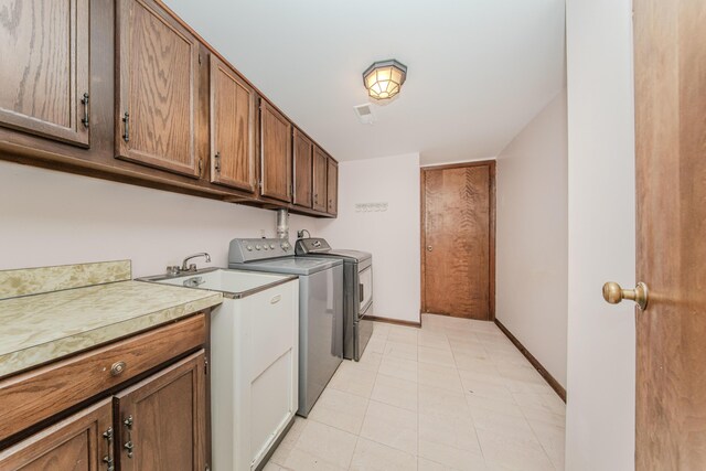 4710 Cove Rd, West Bloomfield, MI 48323 - laundry area featuring washer and clothes dryer, cabinet space, baseboards, and light tile patterned flooring