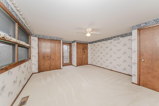 4710 Cove Rd, West Bloomfield, MI 48323 - unfurnished bedroom featuring wallpapered walls, carpet flooring, baseboards, and ceiling fan