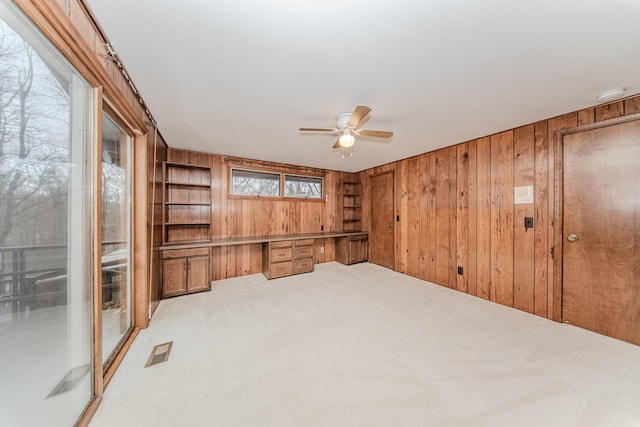 4710 Cove Rd, West Bloomfield, MI 48323 - unfurnished room featuring wooden walls, a ceiling fan, light colored carpet, and a smoke detector