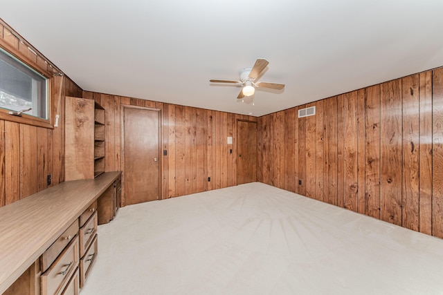 4710 Cove Rd, West Bloomfield, MI 48323 - spare room with wood walls, ceiling fan, and light carpet