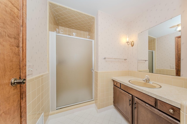 4710 Cove Rd, West Bloomfield, MI 48323 - bathroom featuring tile walls, a wainscoted wall, a shower stall, wallpapered walls, and vanity