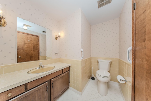 4710 Cove Rd, West Bloomfield, MI 48323 - bathroom with a wainscoted wall, toilet, vanity, wallpapered walls, and tile patterned floors