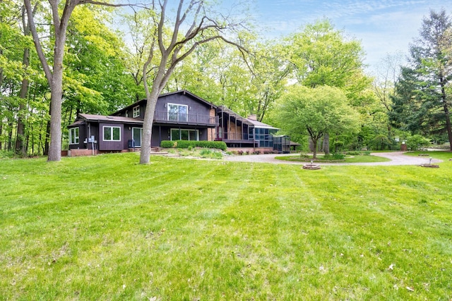 4710 Cove Rd, West Bloomfield, MI 48323 - back of house featuring a yard, a deck, and view of scattered trees