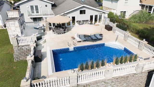 view of swimming pool with french doors, a fenced backyard, outdoor dining space, outdoor lounge area, and a patio area