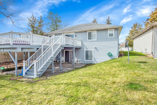rear view of property featuring a yard, a patio area, a deck, and stairs