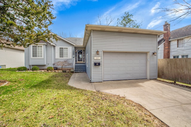 ranch-style home featuring concrete driveway, fence, and a front lawn