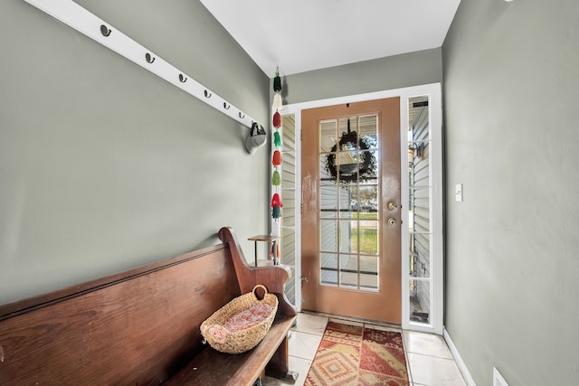 entryway with a healthy amount of sunlight, baseboards, and tile patterned flooring
