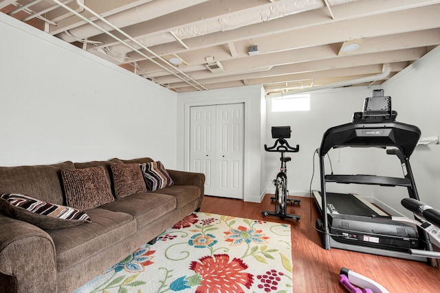 workout room with baseboards and wood finished floors