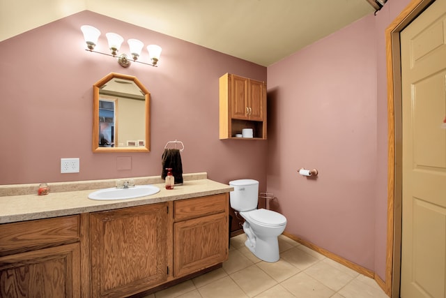 bathroom with toilet, tile patterned floors, vanity, and baseboards