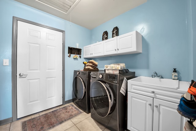 clothes washing area with separate washer and dryer, light tile patterned flooring, attic access, a sink, and cabinet space