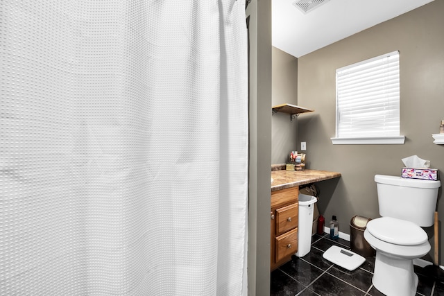 bathroom featuring vanity, baseboards, tile patterned flooring, toilet, and visible vents