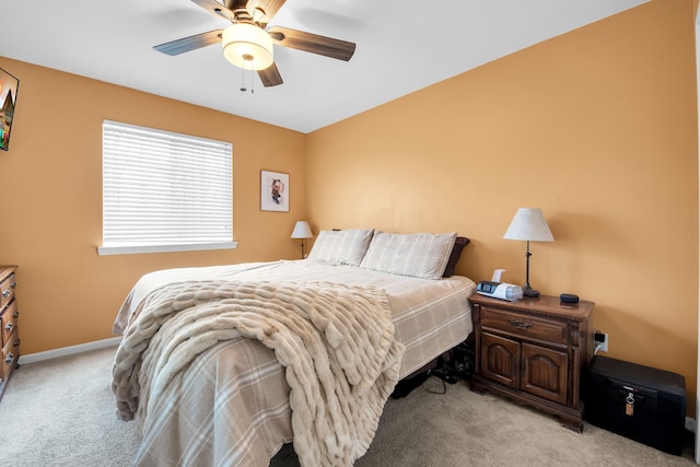 bedroom featuring ceiling fan, light colored carpet, and baseboards
