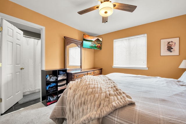 bedroom with a ceiling fan and carpet flooring