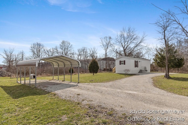 exterior space featuring a carport, dirt driveway, and a yard