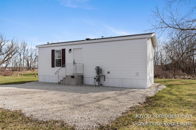 back of property featuring a yard