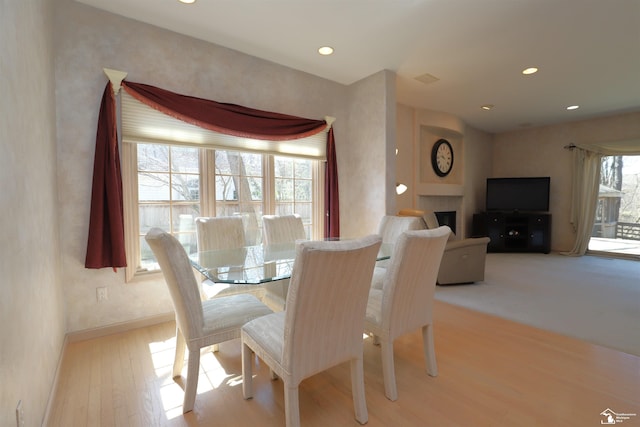 7241 Hidden Valley Dr, Lambertville, MI 48144 - dining room with recessed lighting, a fireplace, and wood finished floors