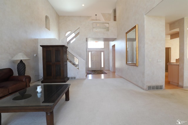 7241 Hidden Valley Dr, Lambertville, MI 48144 - carpeted living area with a towering ceiling, stairway, and visible vents