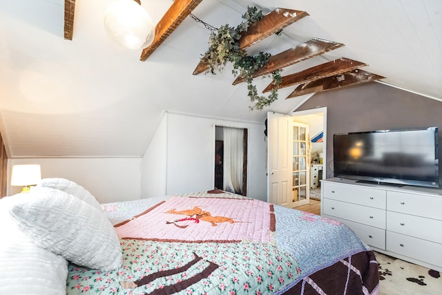bedroom with lofted ceiling with beams