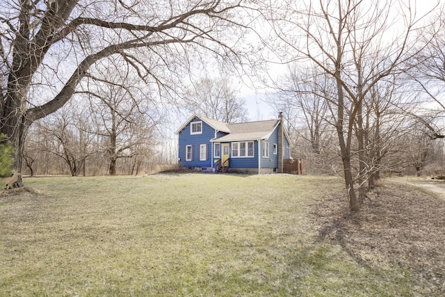 view of front of home with a front lawn and a chimney
