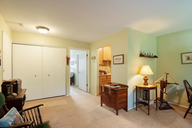 living area with light carpet and baseboards