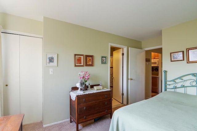 bedroom with a closet and light carpet