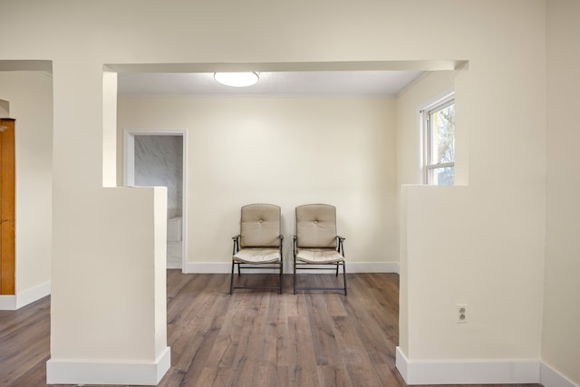 living area with wood finished floors and baseboards