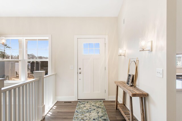 entrance foyer featuring baseboards and wood finished floors