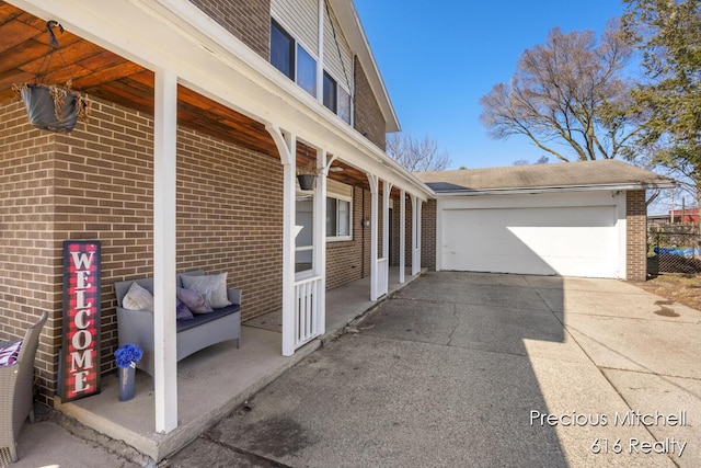 exterior space with a detached garage and brick siding