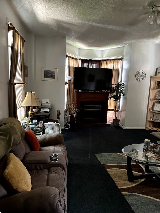 living room featuring carpet flooring, a fireplace, and a textured ceiling