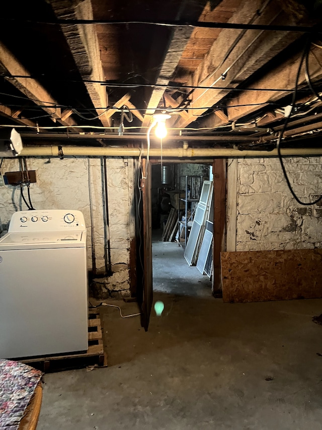 unfinished below grade area with washer / clothes dryer