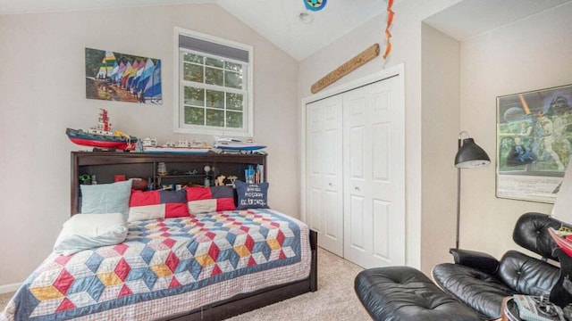 bedroom featuring vaulted ceiling, carpet, and a closet