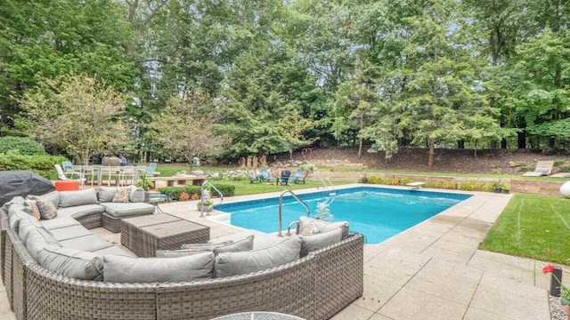 outdoor pool with a patio and outdoor lounge area