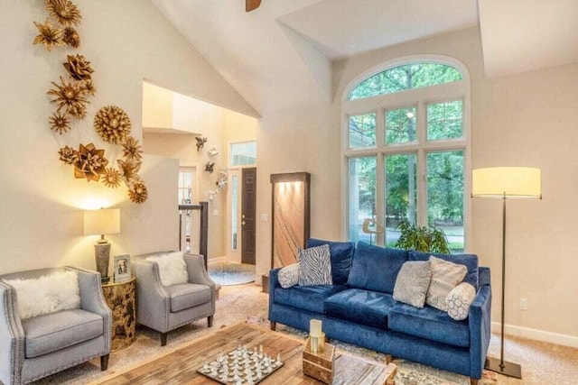 living room with a high ceiling and baseboards