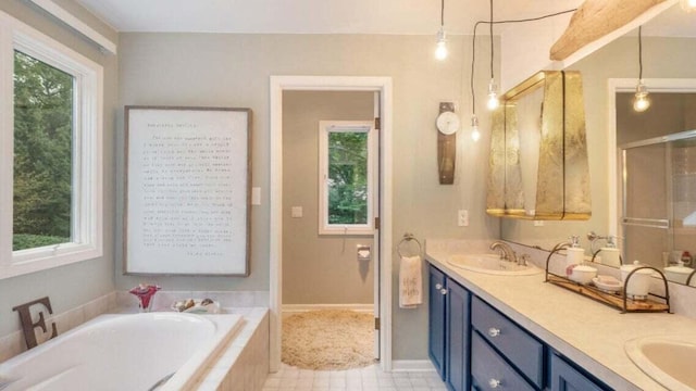 bathroom with a sink, plenty of natural light, and a bath