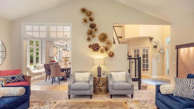 living area featuring french doors and high vaulted ceiling