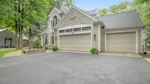 3820 Harbor Point Dr, Norton Shores, MI 49441 - traditional-style home with a garage, a shingled roof, and aphalt driveway