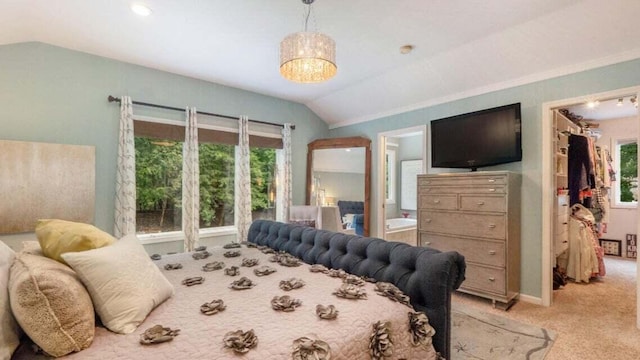 bedroom featuring multiple windows, lofted ceiling, and light carpet