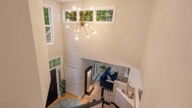 entryway featuring plenty of natural light, a high ceiling, and a chandelier